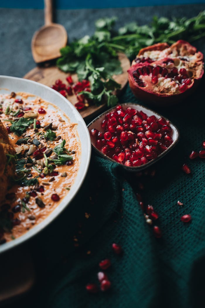 service-04 A deliciously styled vegan dish topped with vibrant pomegranate seeds, perfect for healthy meal inspiration.